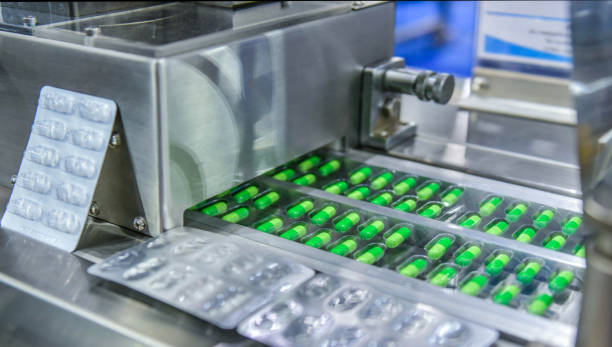 Green capsule medicine pill production line, Industrial pharmaceutical concept.